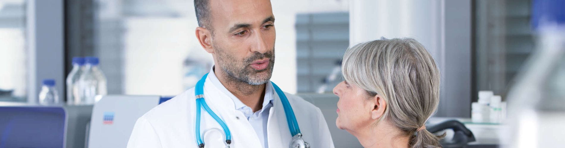Male scientist (doctor) and female pathologist discussing data
